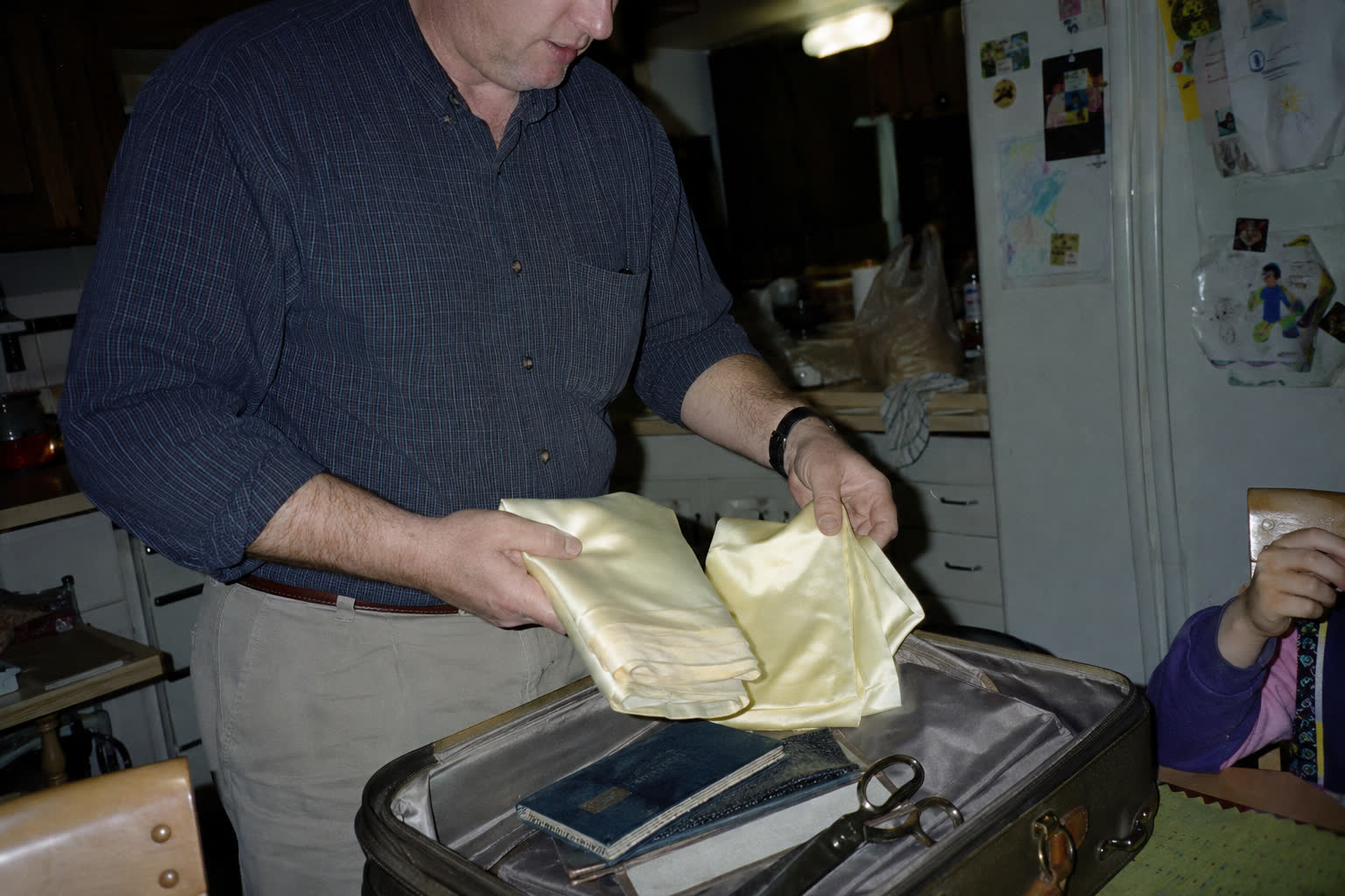 Peter unpacking silk and tools from a suitcase
