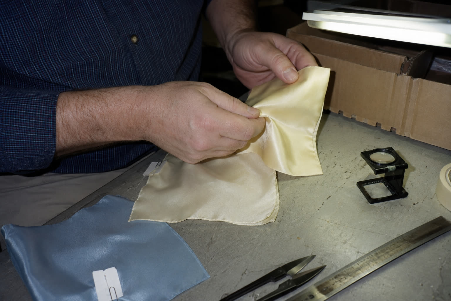 A silk seam being inspected by hand